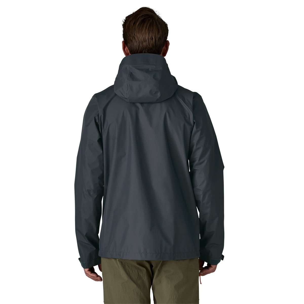 A man wears the Torrentshell jacket and faces away, showing off the back view of the jacket