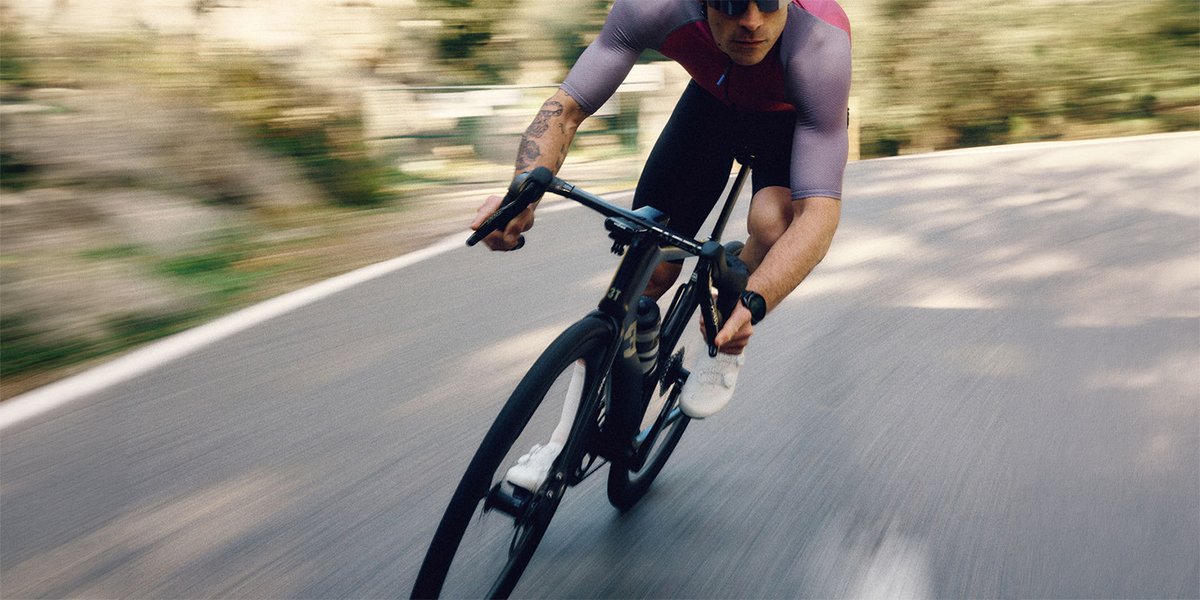 Claude responded: Male road cyclist in a purple and red jersey sprinting on a black 3T road bike with deep-section carbon wheels, motion blur on road and background.Male road cyclist in a purple and red jersey sprinting on a black road bike with deep-section carbon wheels, motion blur on road and background.