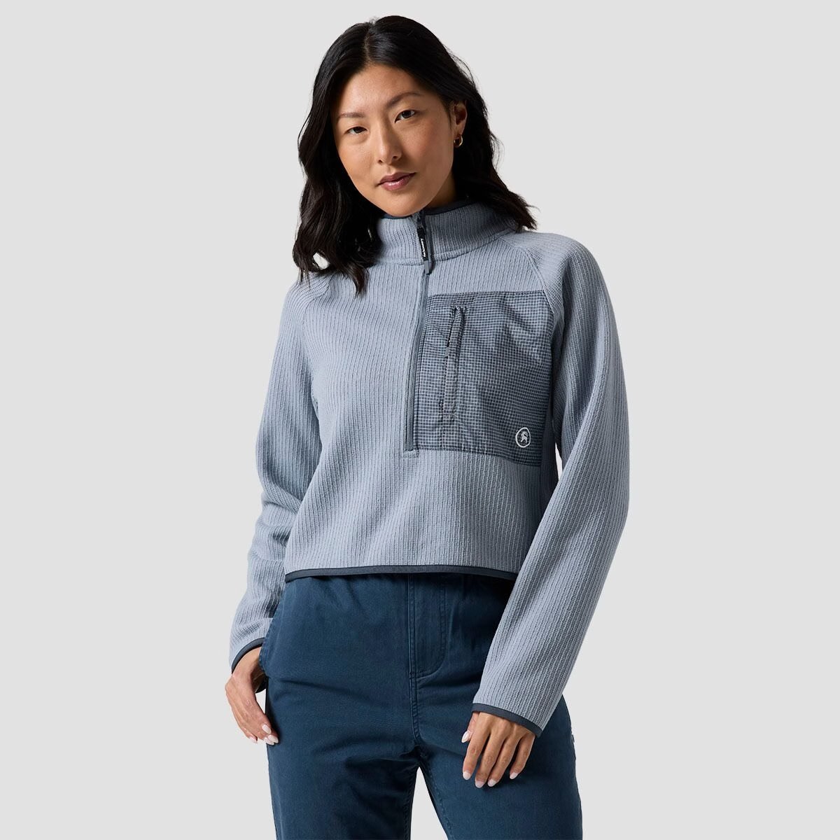 A woman wears the BGA Wander Sweater Fleece 1/2 zip.