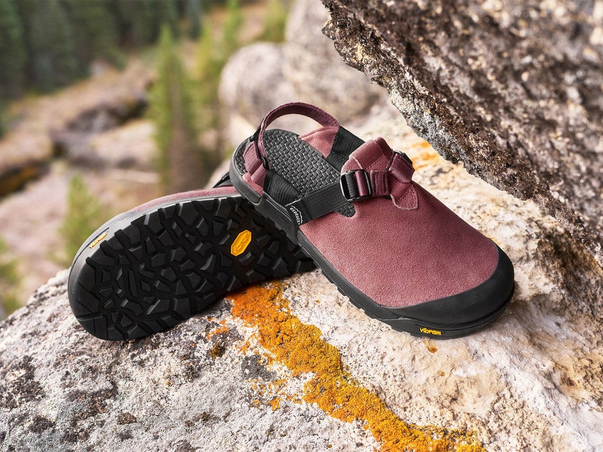 Bedrock Mountain Clog in Wild Rose leather suede shown from side and sole on lichen-covered granite