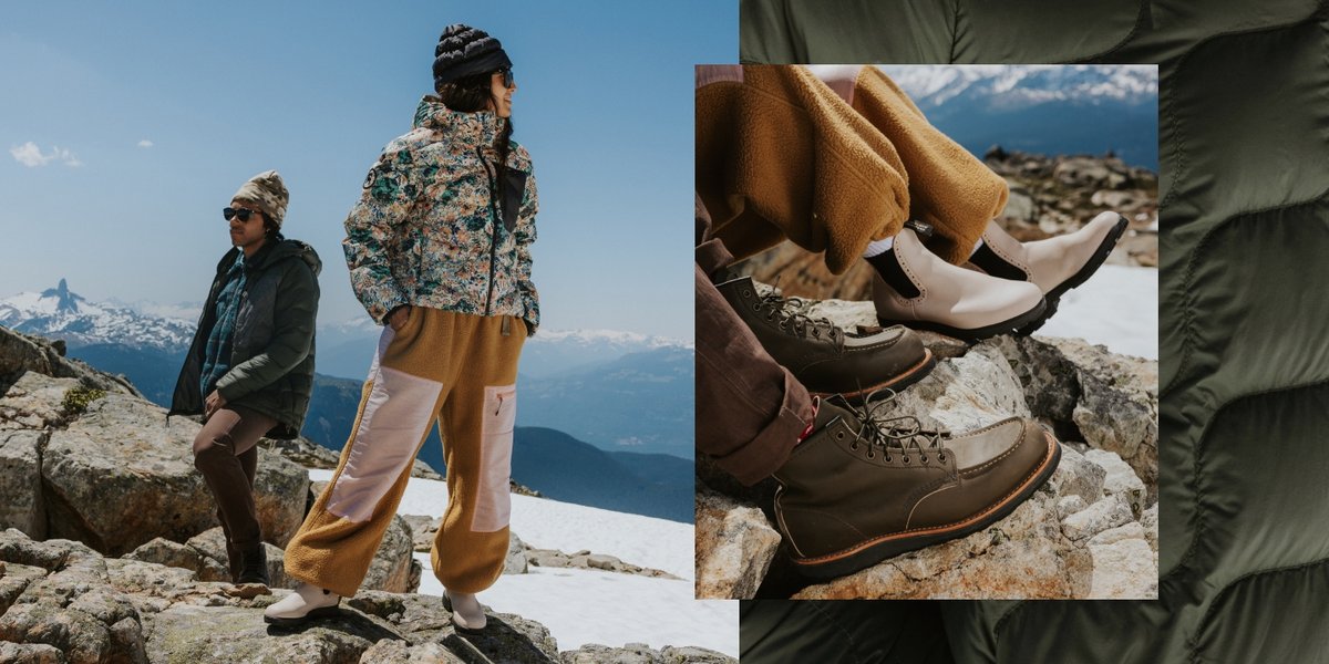 A man and a woman wearing new Backcountry puffy jackets, fleece, and flannels gaze at distant snow-capped mountains from a rocky ridge line. Closeup of Blundstone Chelsea boots and Red Wing Classic Moc boots.