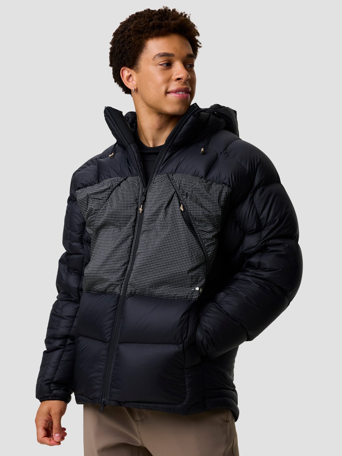 A man wears the BGA Waas ALLIED Down Belay Jacket. 