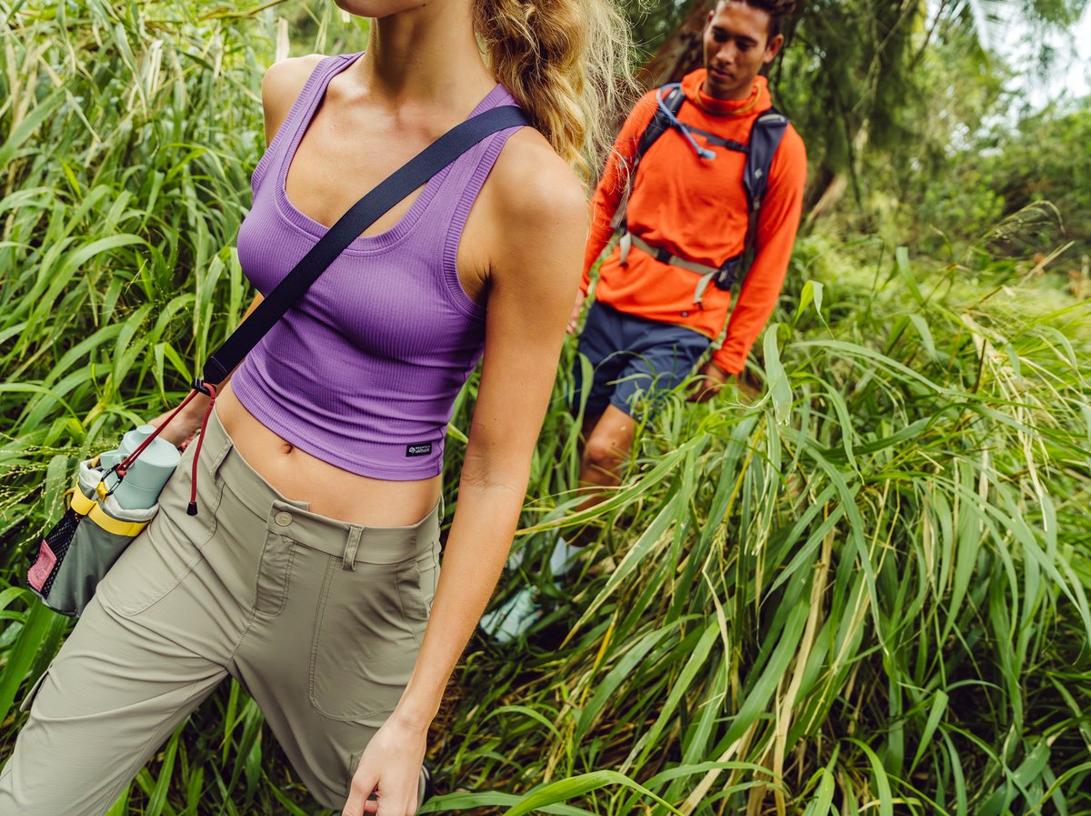 Two hikers navigating dense tropical vegetation