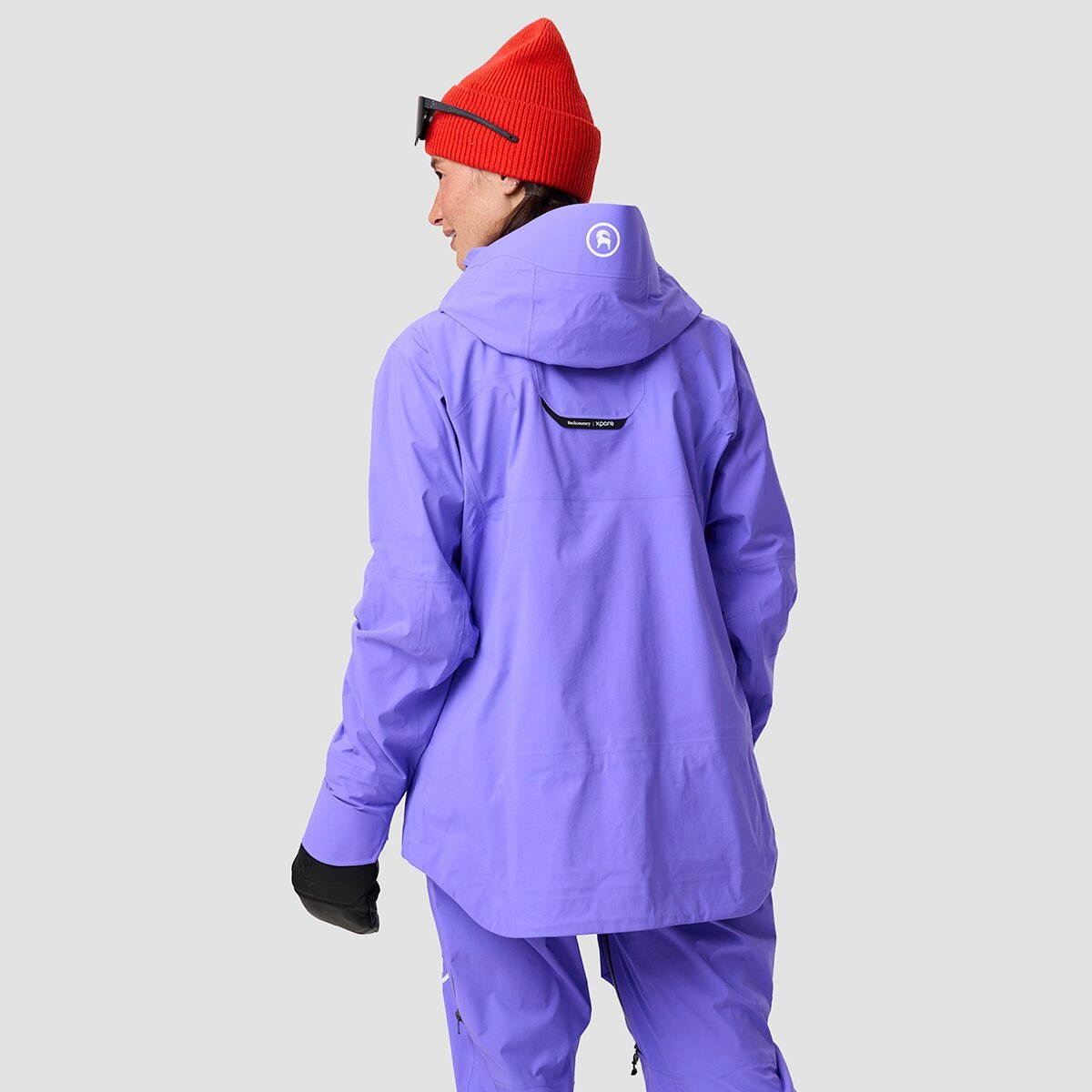 Back of person wearing Cottonwoods LT kit showing extended length of jacket hem.