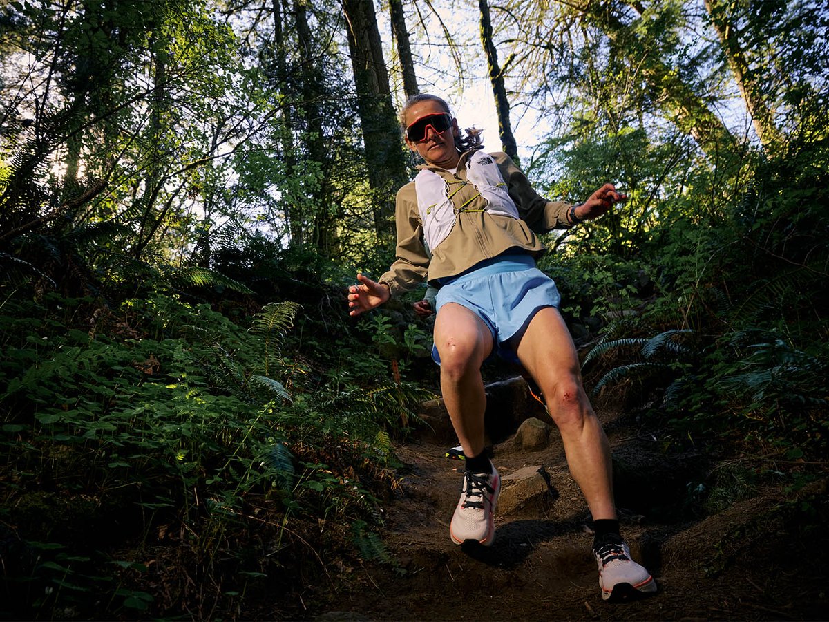 Shot from below of runner descending steep rocky trail.