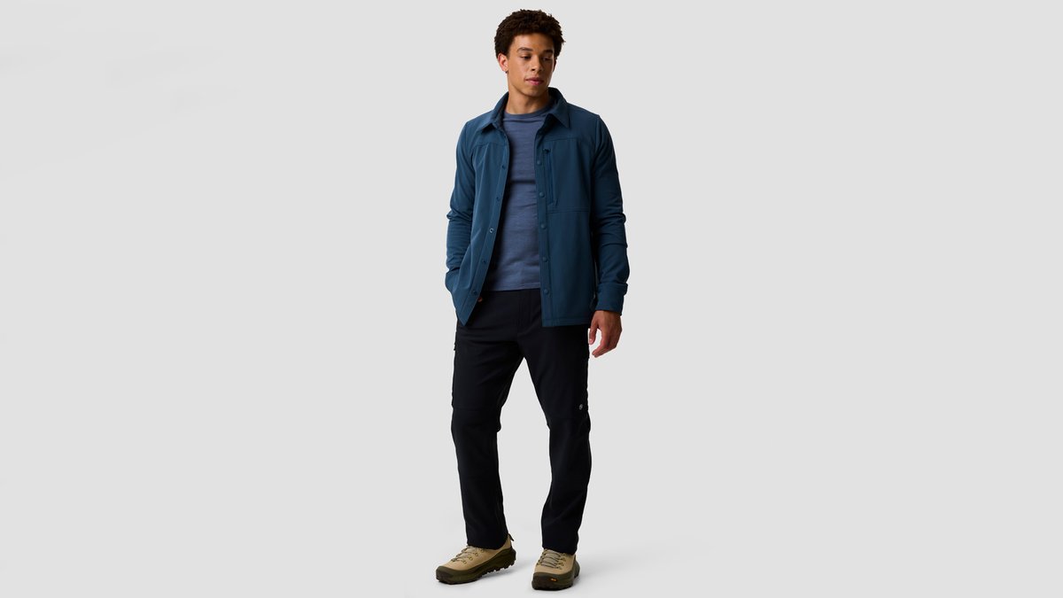 A man wears the Destination Softshell against a gray background.