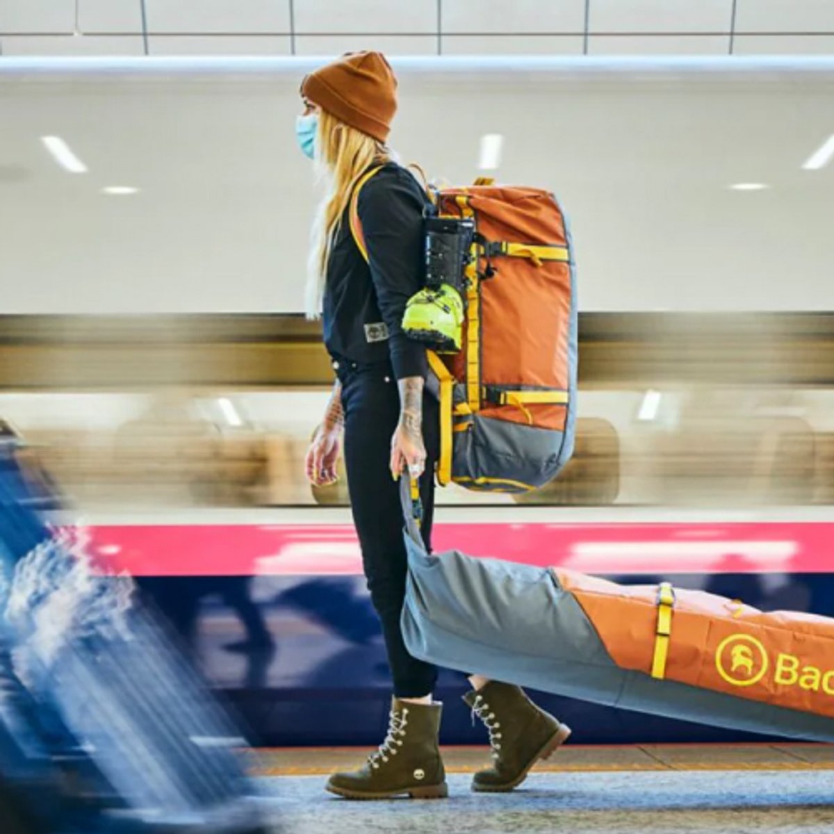 An airport traveler wheels a rolling ski bag through the terminal. 