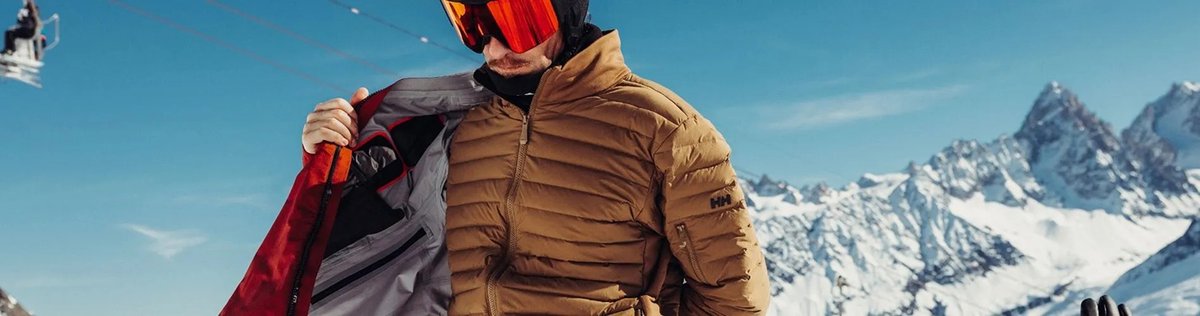 Man checking his jacket liner in front of chair lift