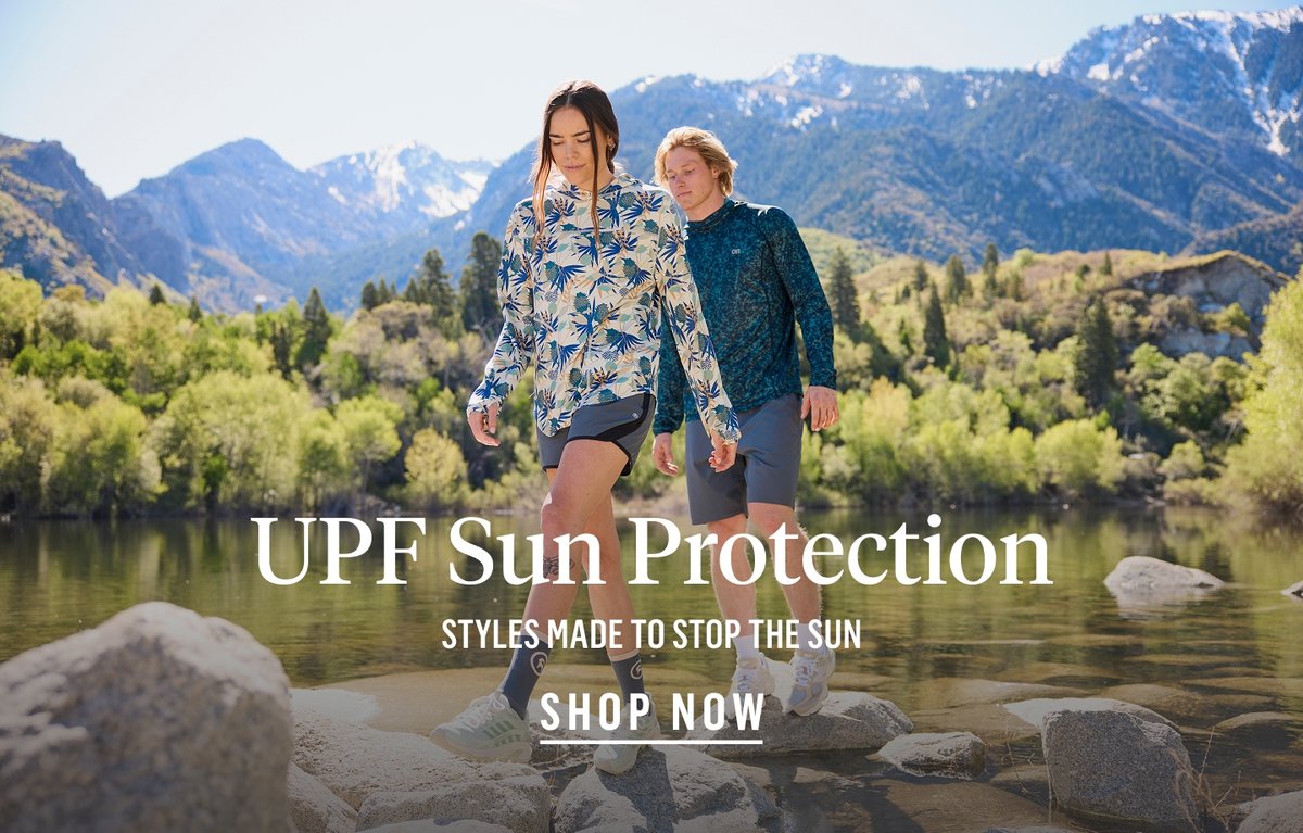 A man swims in the ocean wearing a green Tahoe Sun Hoodie. The words, “UPF Sun Protection, styles made to stop the sun” appear under him in the water.