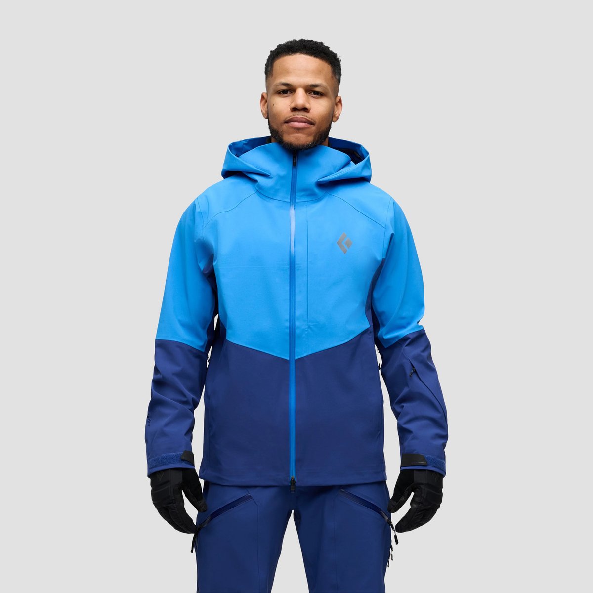 A man looks straight ahead, wearing the Black Diamond Recon Stretch Jacket.