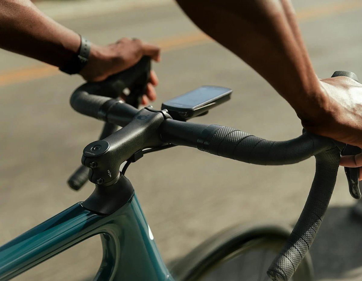 Close shot of person holding handlebars of road bike.