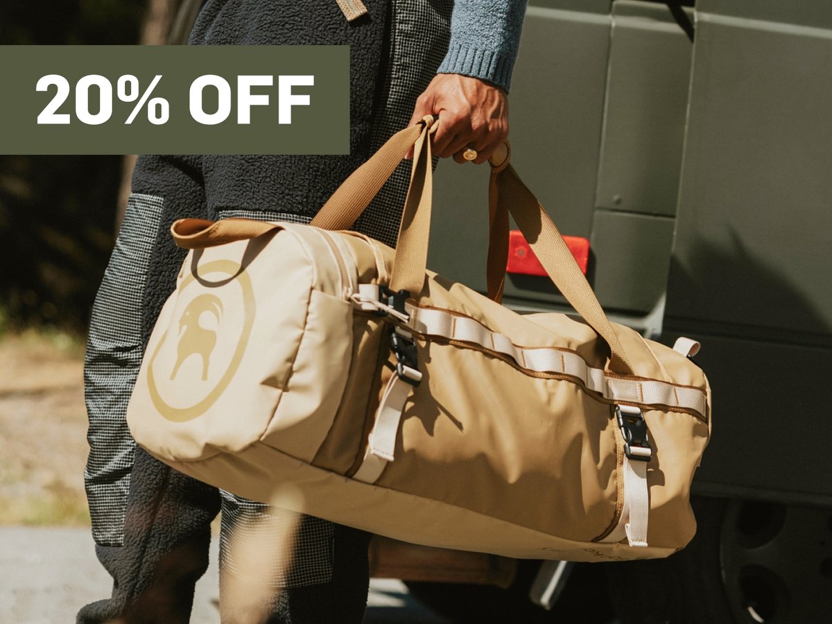 someone carries a bag.  A promotional flag says 20% off in the top right corner.