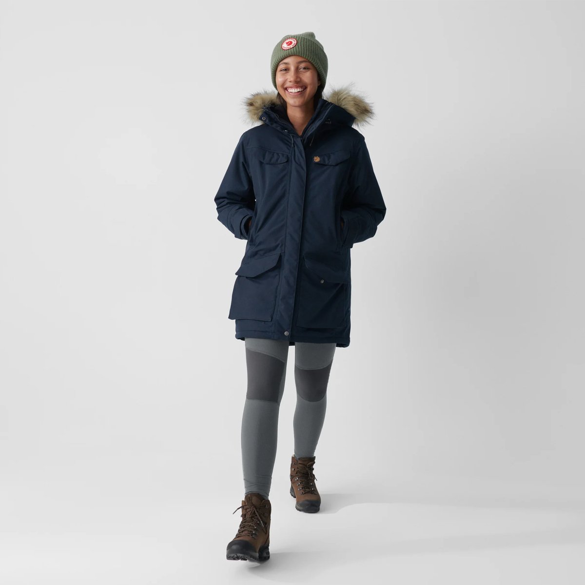A woman walks while wearing the Fjallraven Nuuk Parka.