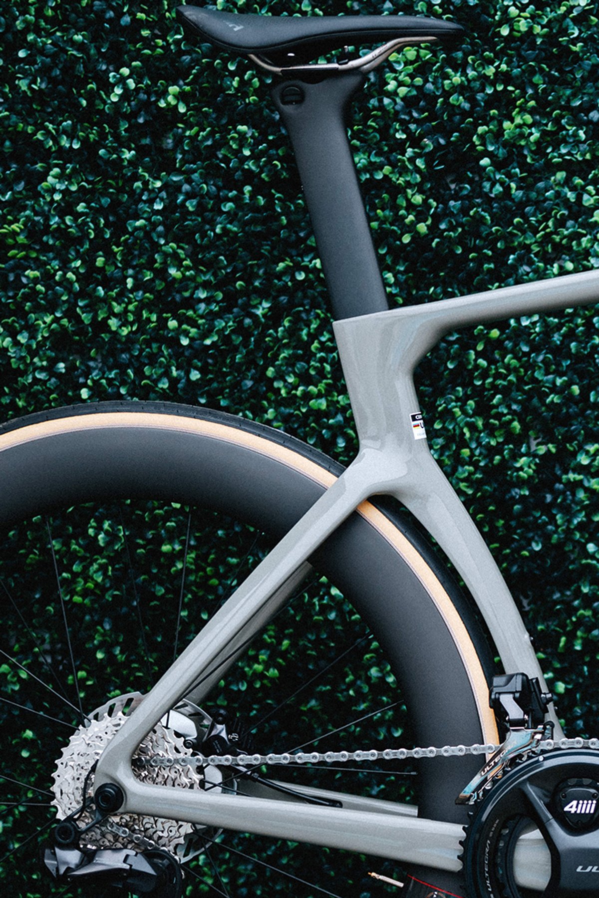 Close-up of a road bike rear triangle with drivetrain and rear wheel.