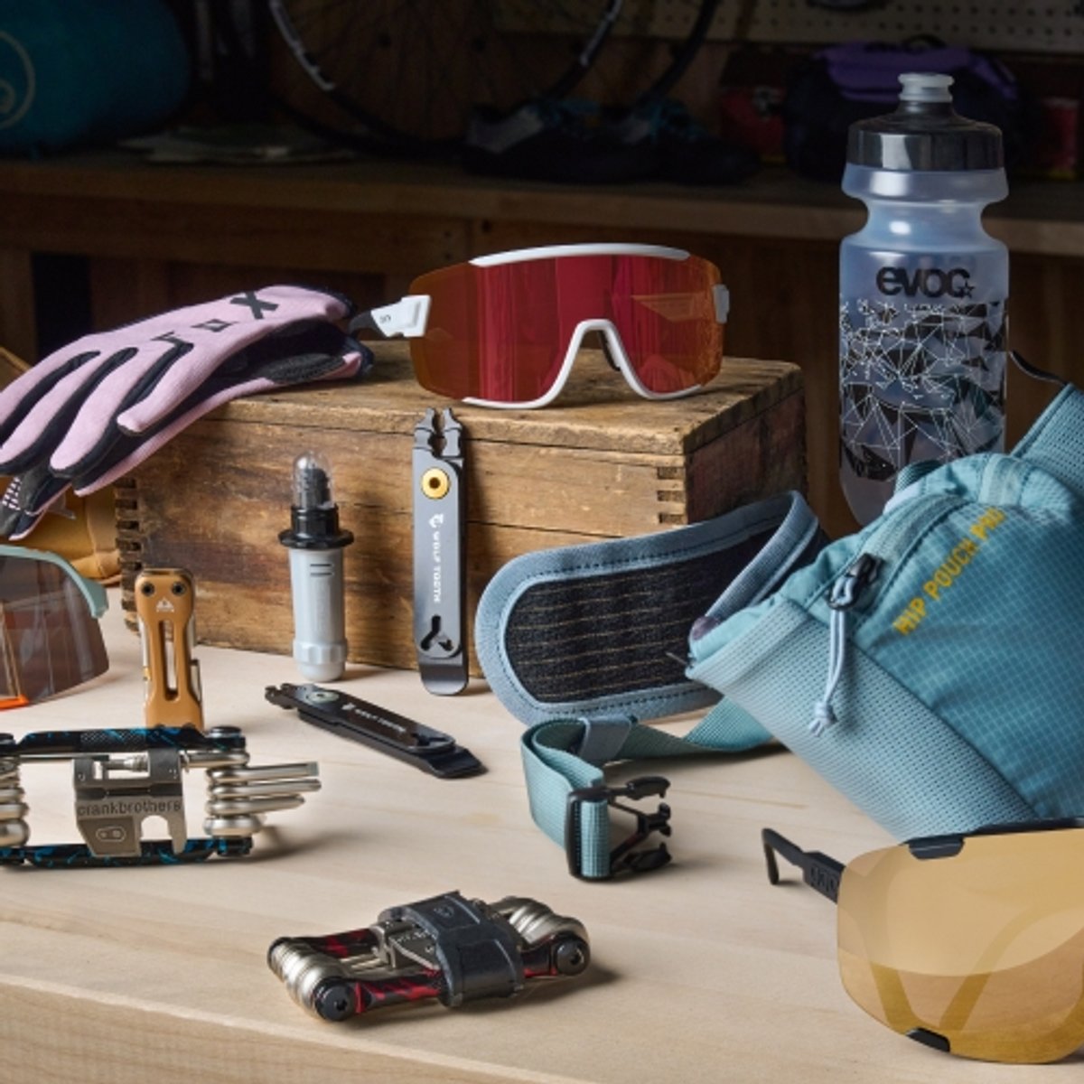 Bike tools and accessories spread on top of a work bench.