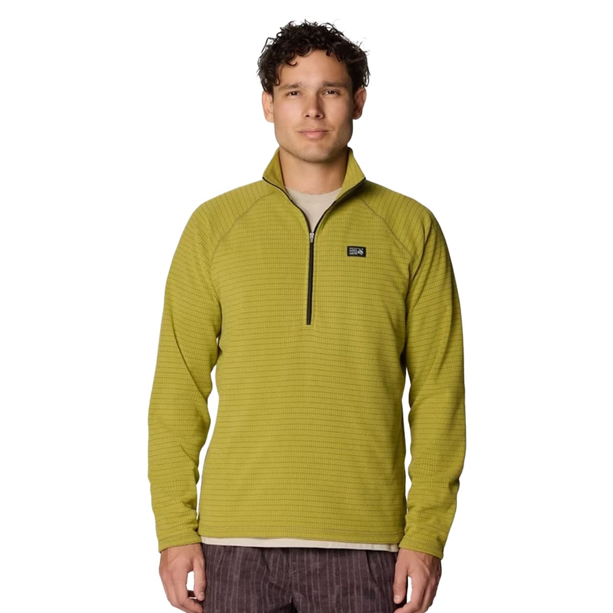 A man wears the Summit Grid 1/2 Zip Fleece Jacket. 