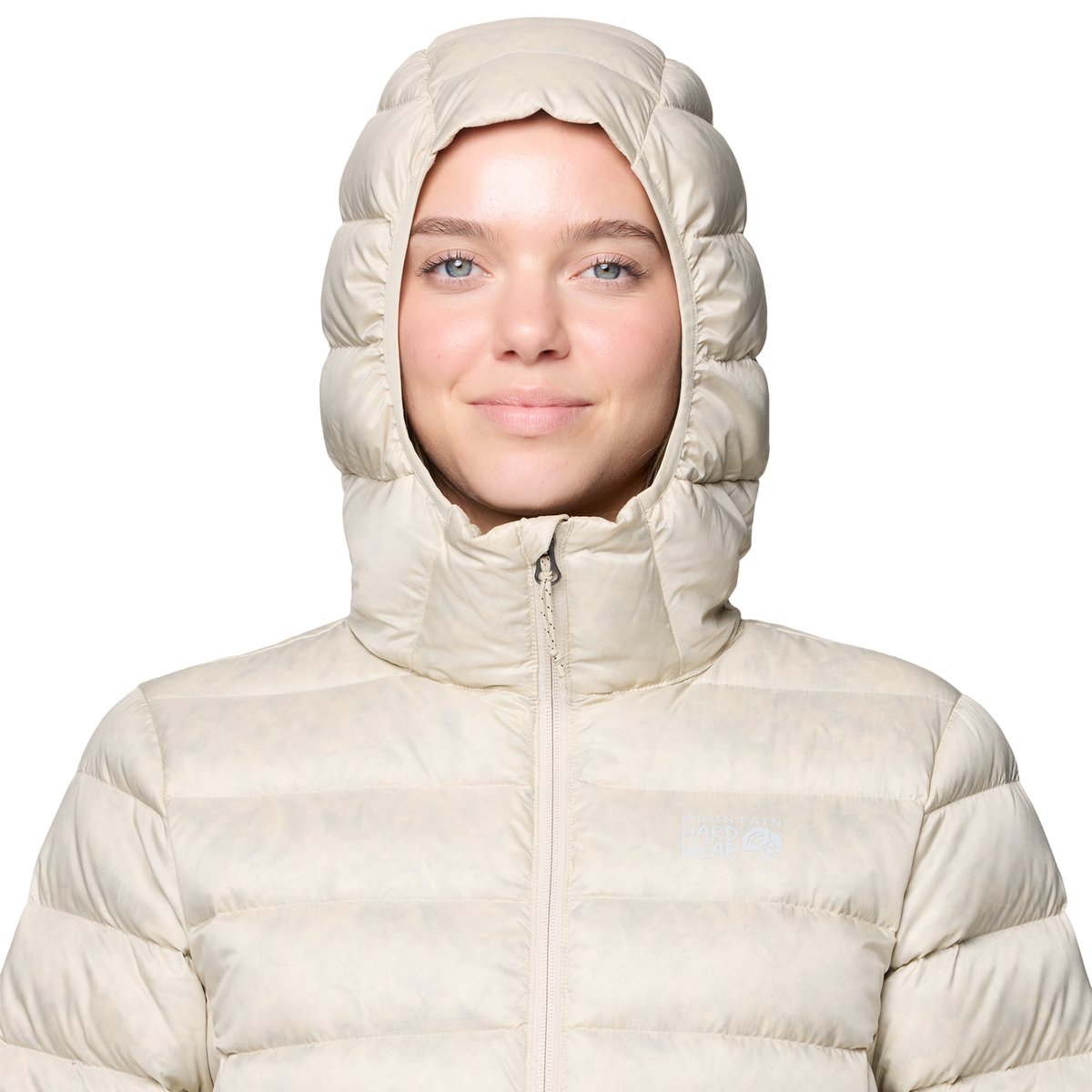 A closeup of a woman wearing the Tiberondack Down Parka hood securely on her head