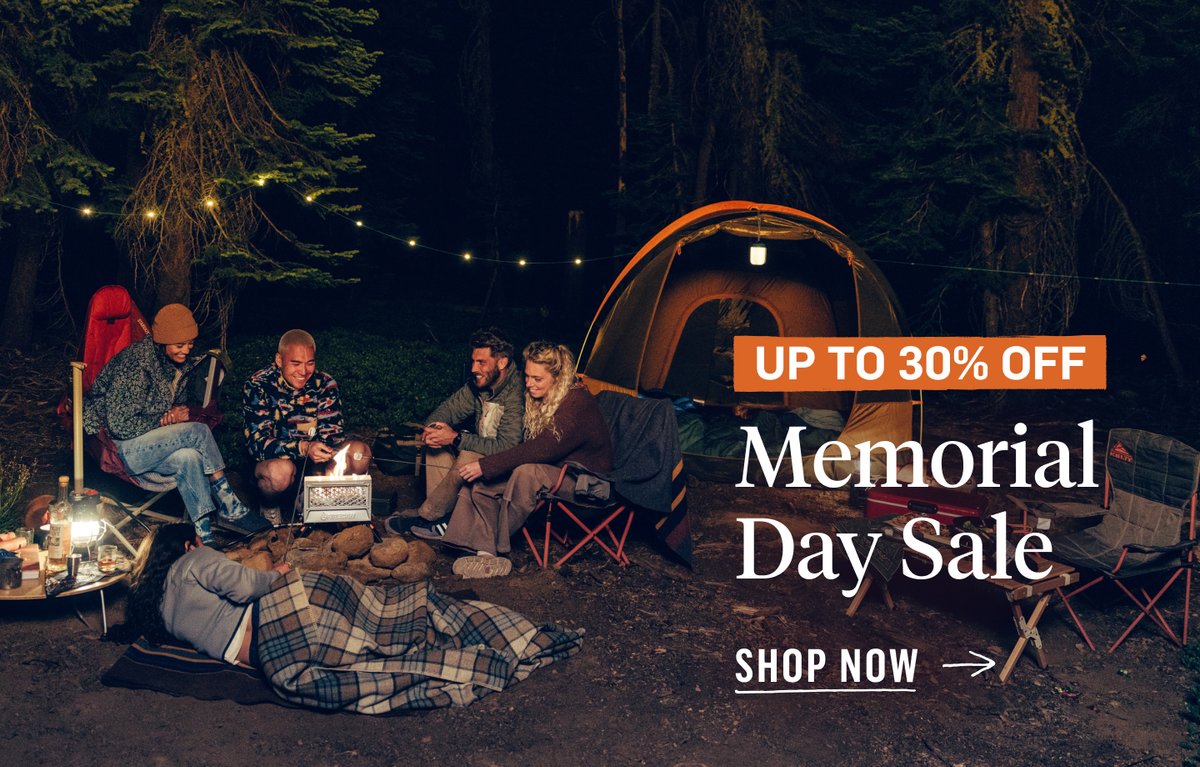 A group of people sit around a campfire. A tent and string lights are in the background. Next to the group, promotional text reads, “Memorial Day Sale, Up to 30% off”.