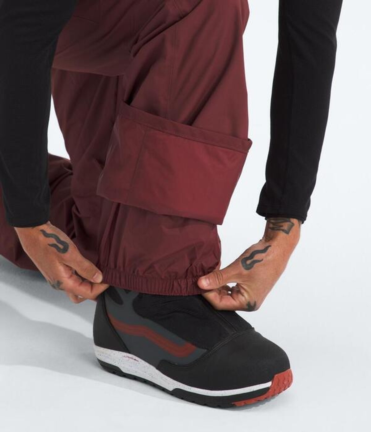Person adjusting the gaiters over their boots.