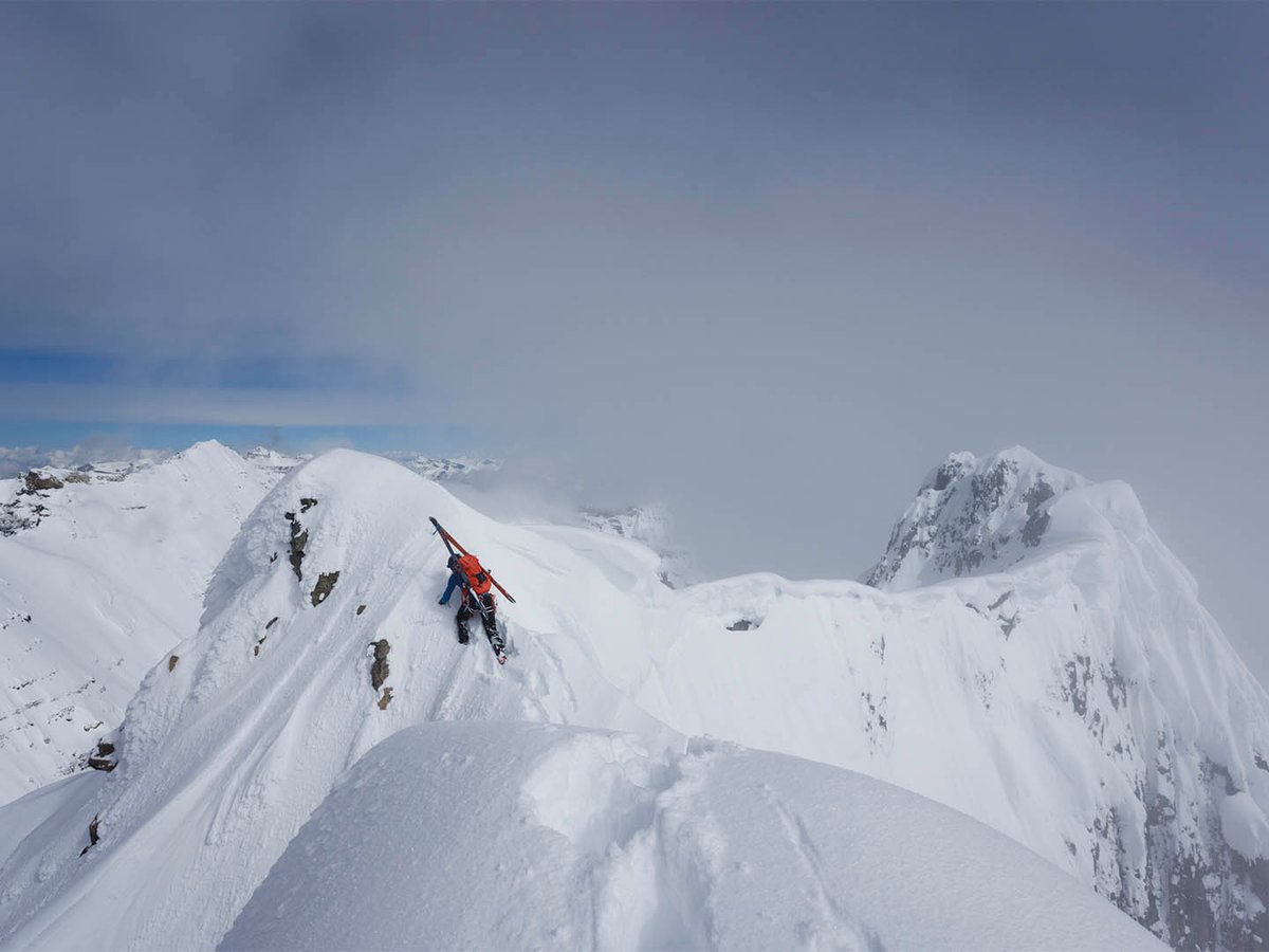 Person on snowy mountain ridge.