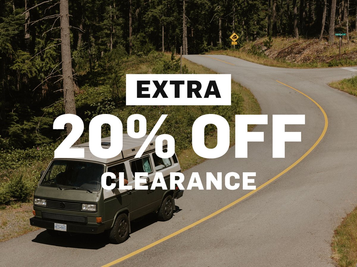 Extra 20% off clearance — a retro van drives on the road.