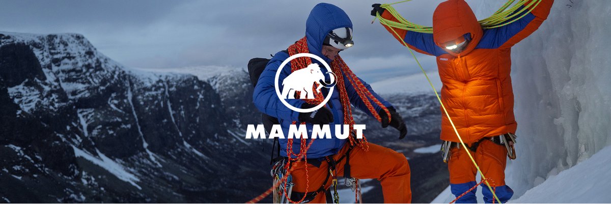 The Mammut logo layered over a photo of a pair of mountaineers flaking ropes on a snowy mountain side at dusk.