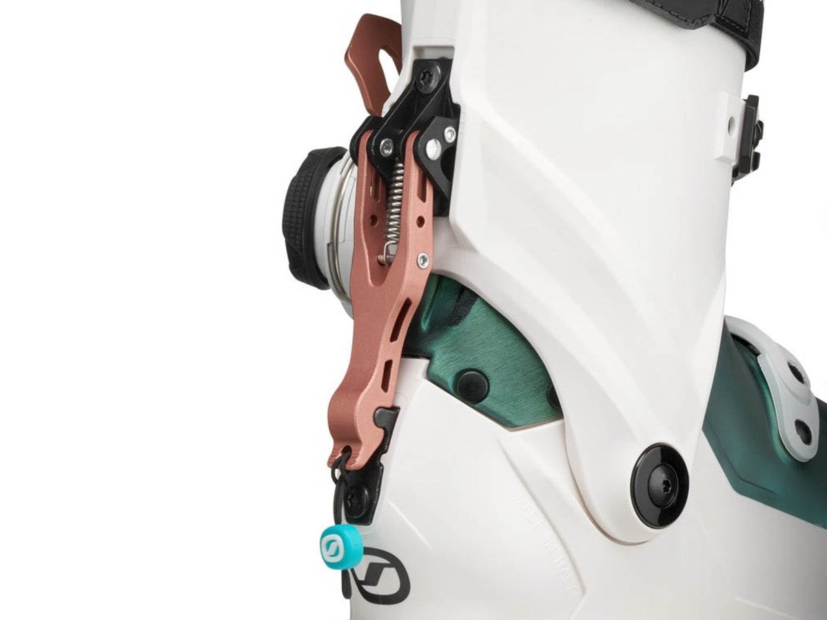Close-up of SCARPA F1 RS FS Lever walk mode mechanism on women's white shell with rose gold lever arm and BOA dial visible