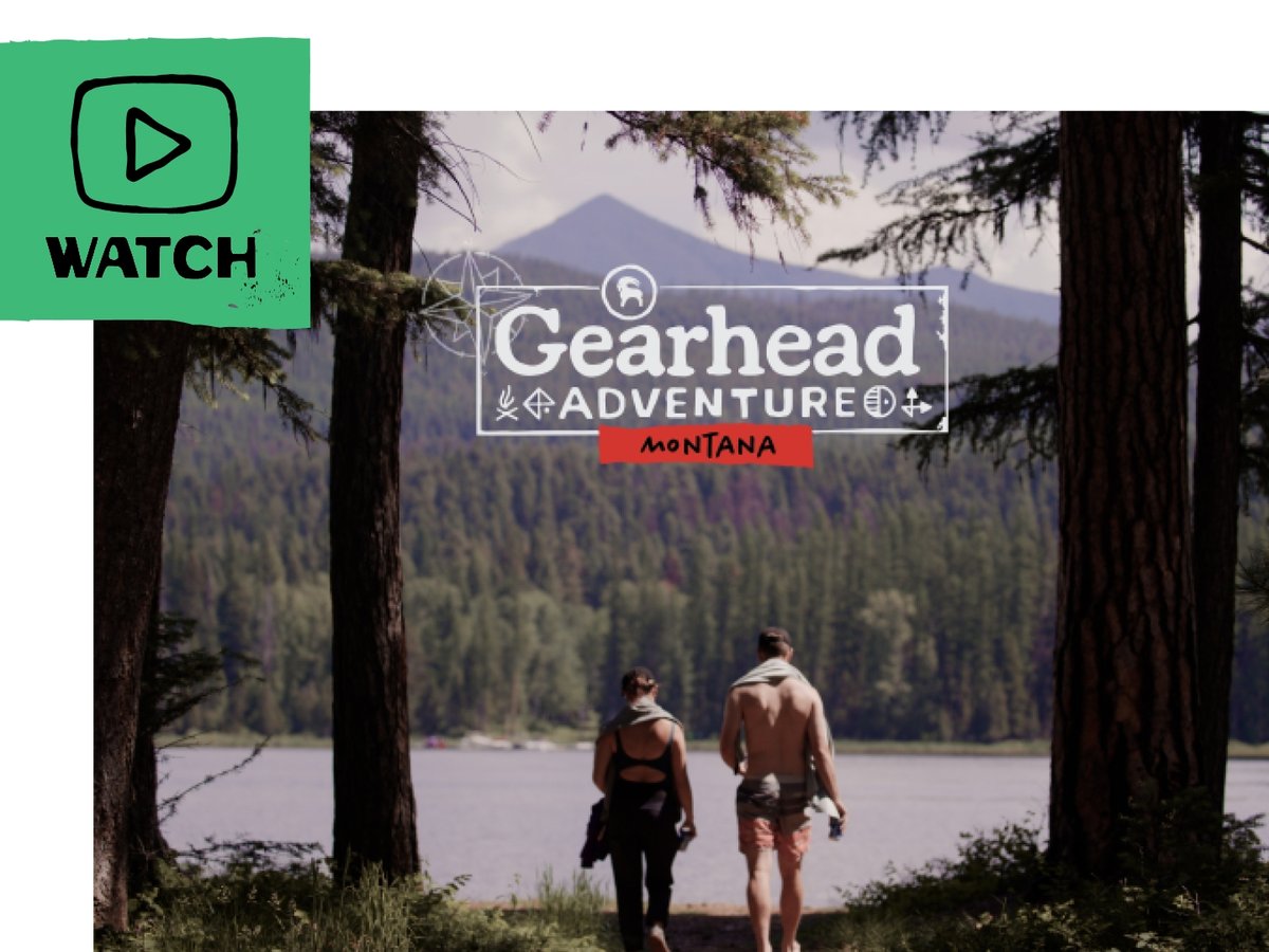 A man and a woman wearing swimming attire walk towards an alpine lake. A flag in the upper left corner shows an illustrated play button and includes the text “Watch”.Gearhead® Adventure | Ep. 1