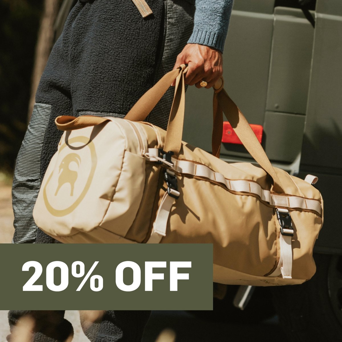 someone carries a bag.  A promotional flag says 20% off in the top right corner.