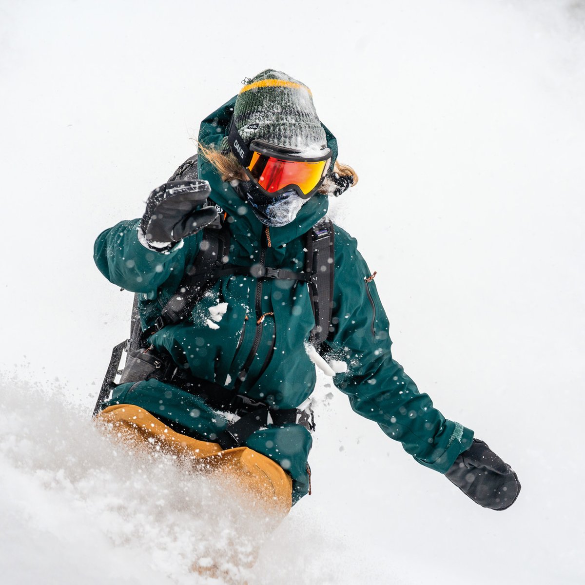 Purple bindings are mounted on orange skis.