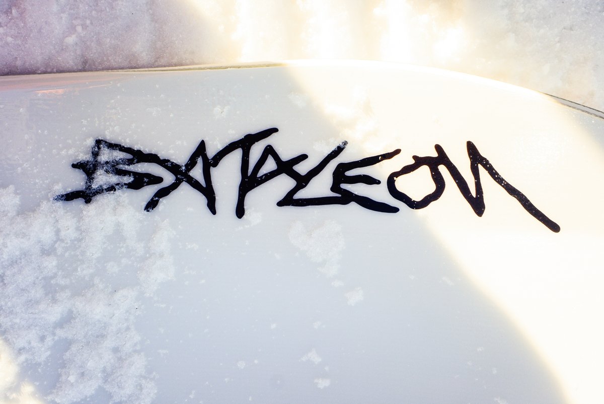 Bataleon snowboard topsheet with Bataleon logo graphic on snow surface