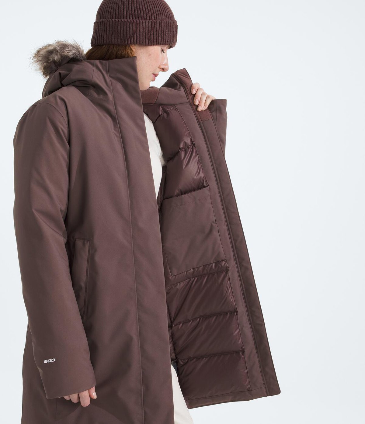 A woman wears an unzipped Arctic Down Parka