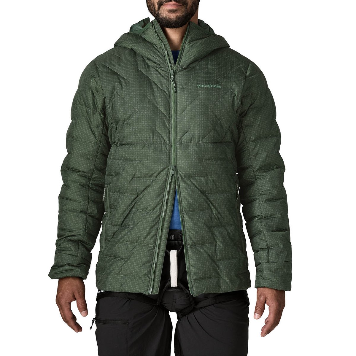 Person wearing down jacket unzipped from bottom with climbing harness exposed.
