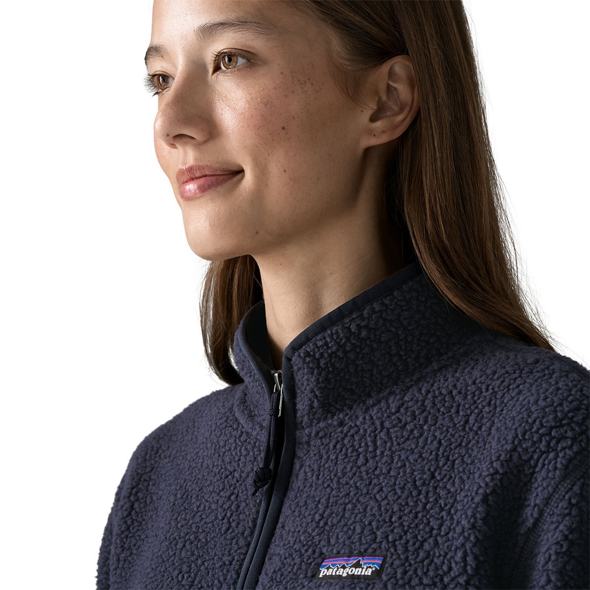 A headshot of a woman wearing the Retro Pile Marsupial Pullover, highlighting the elastic binding around the collar.