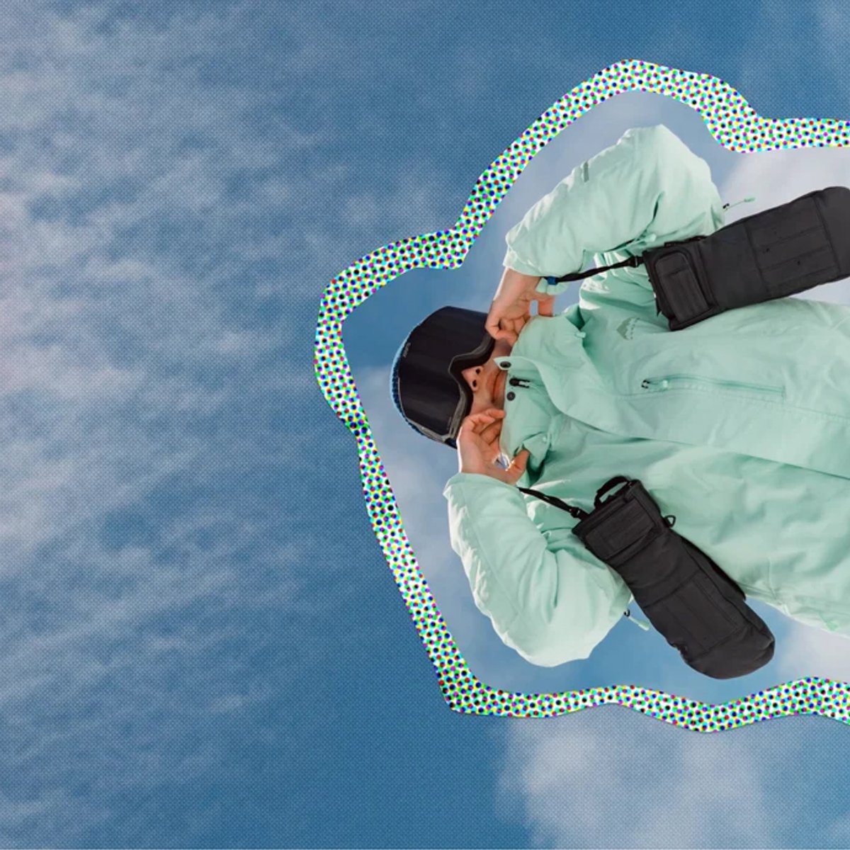 A person wearing a light green puffy jacket and black gloves paddles on turquoise water with a dotted green and white border outline effect.