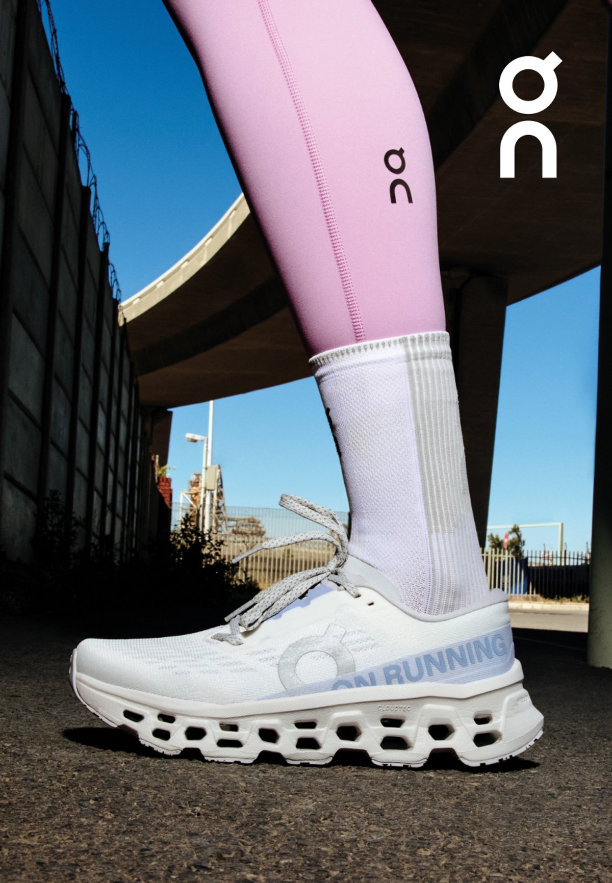 Ankle down shot of person wearing tights, socks and the Cloudmonster 3 shoe. 