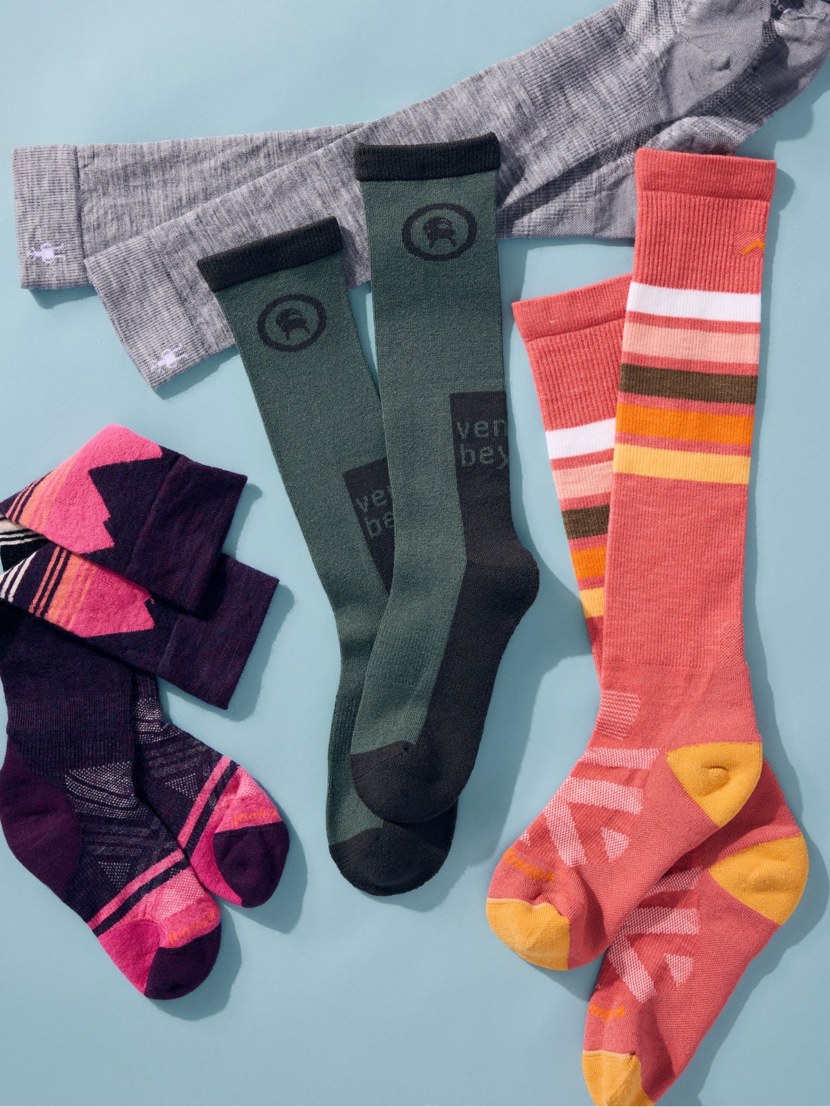 A selection of colorful socks is arranged on a light blue background.
