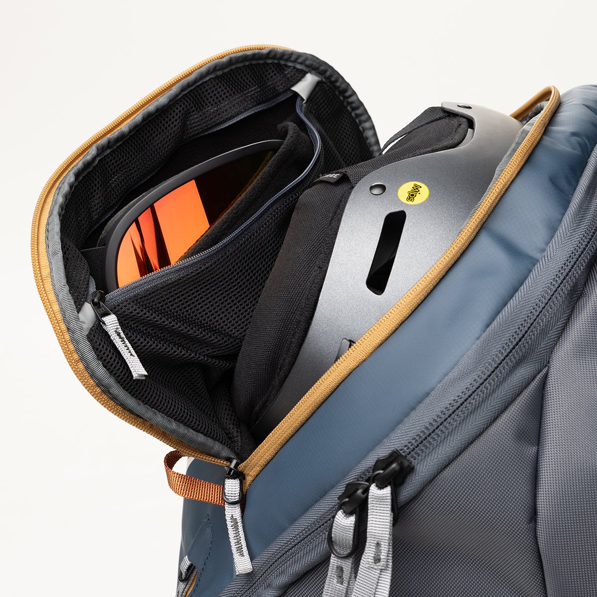 Close-up of fleece-lined zippered goggle pocket within larger helmet pocket.