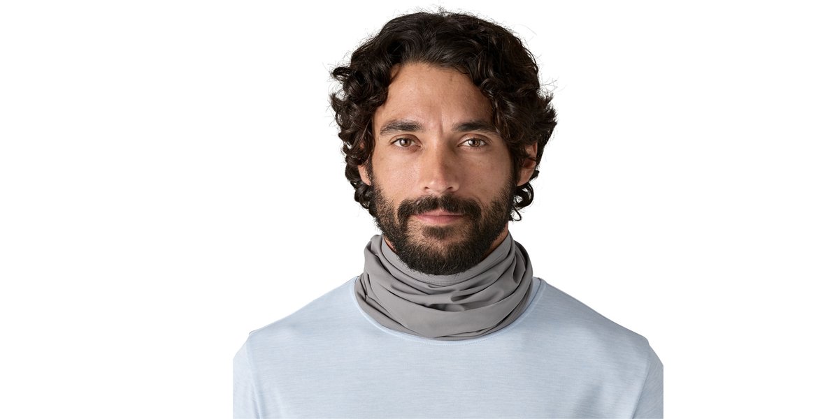 A man wears the Patagonia Sun Mask around his neck. 