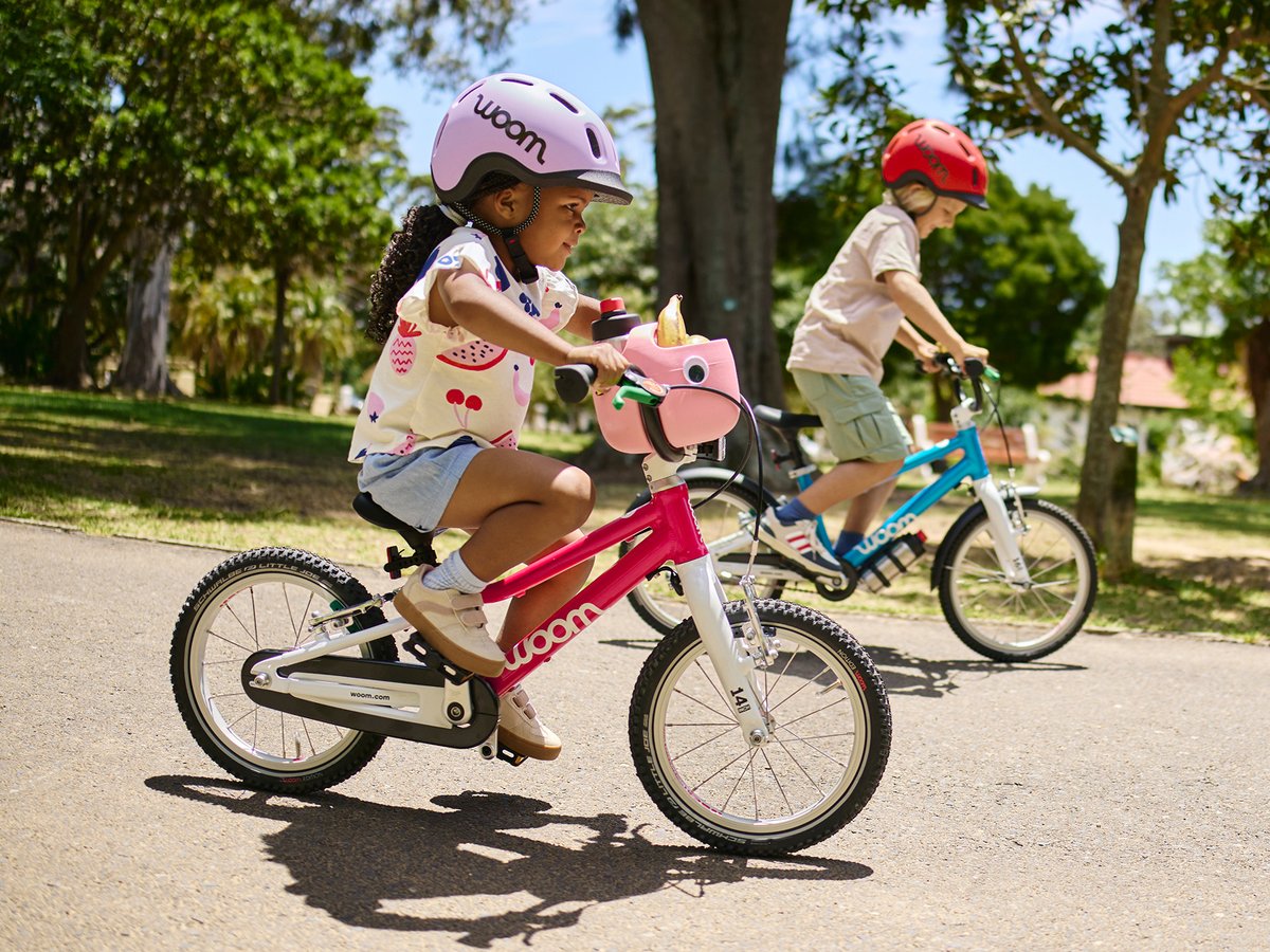 Two kids ride woom bikes.