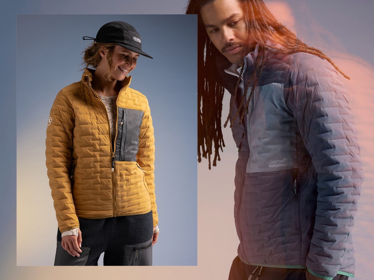 A man and woman wearing matching Peale synthetic puffy jackets.
