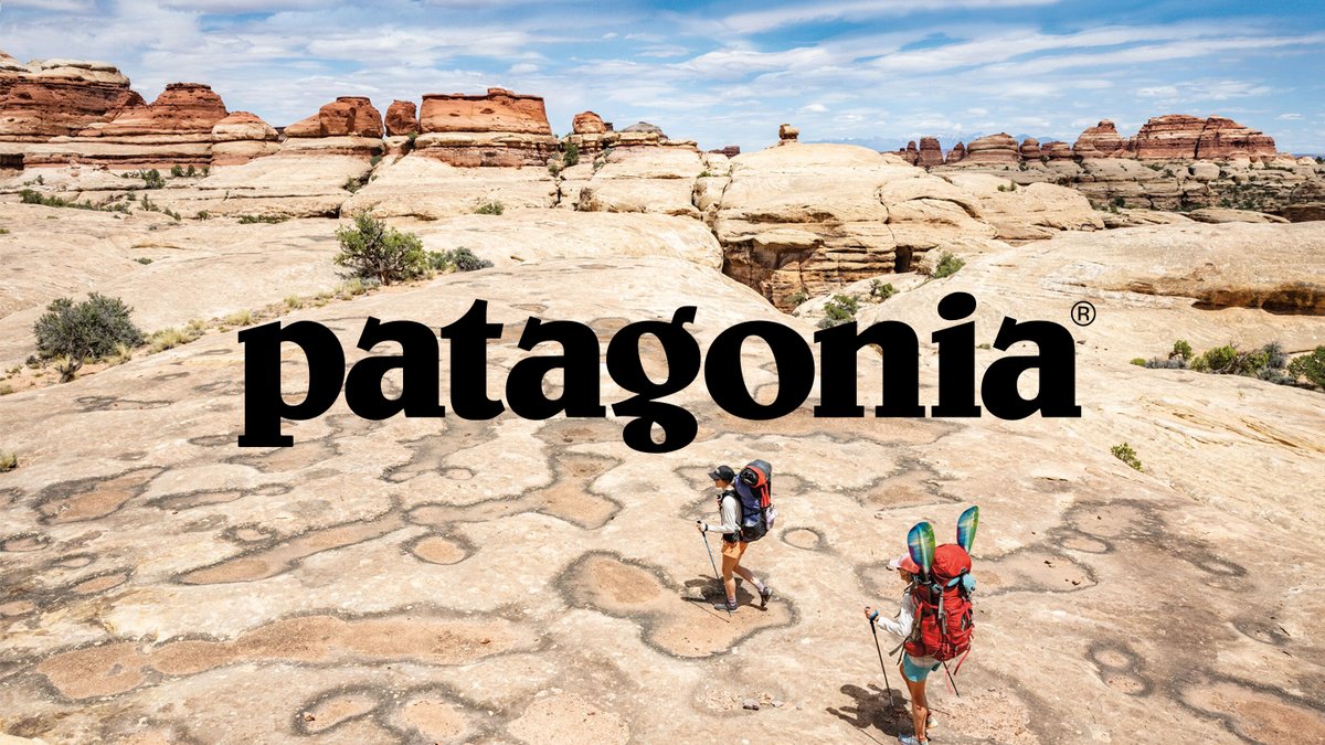 Hikers walking across bare rock with a Patagonia logo overlay.