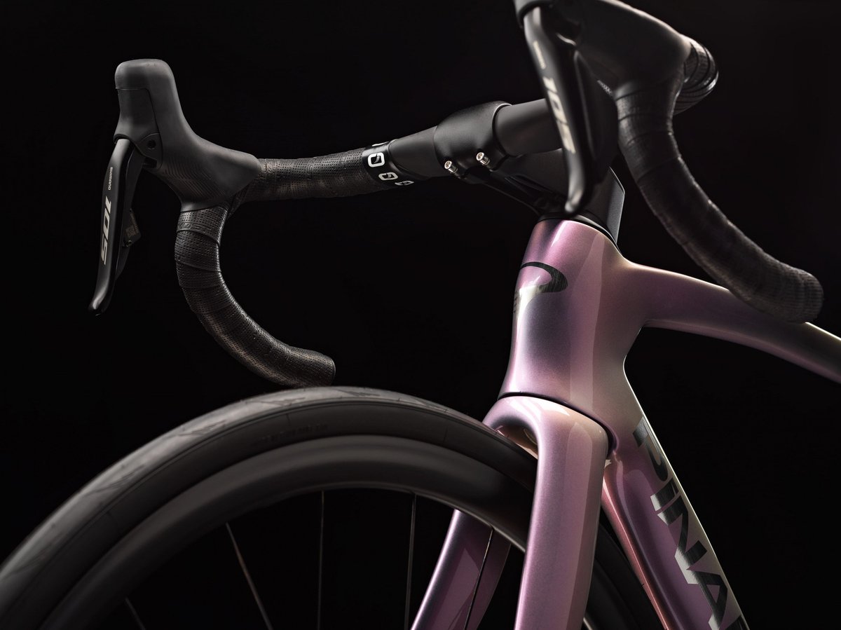 Pinarello road bike carbon frame headtube detail with Shimano 105 drop bar levers and black handlebar tape