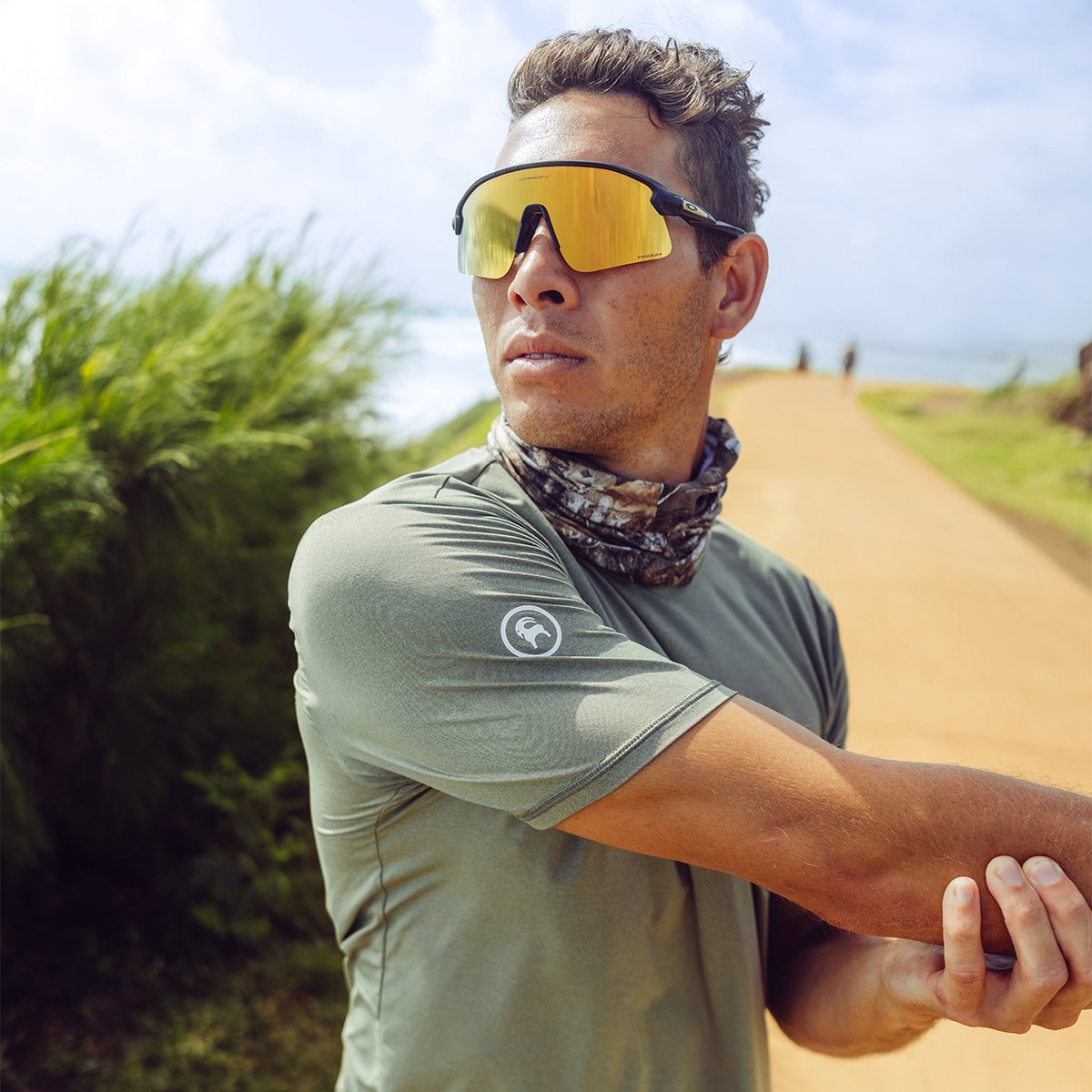 A man wearing the Tahoe Pro LT stretches his arms for a trail run