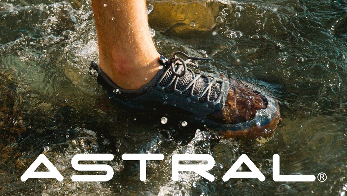 A close-up shot shows an Astral water shoe submerged in splashing river water, highlighting its drainage and grip.