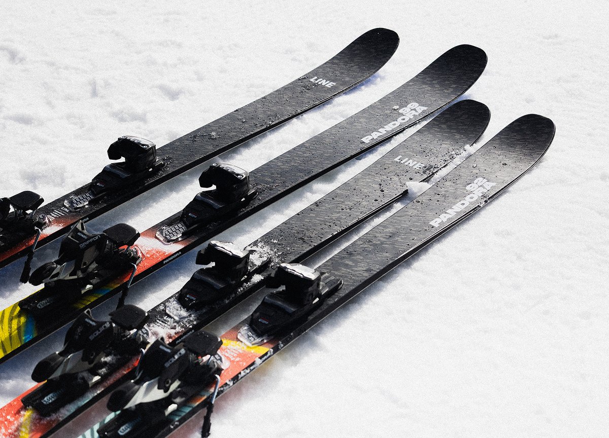 LINE Pandora skis with mounted bindings displayed on snowy ground