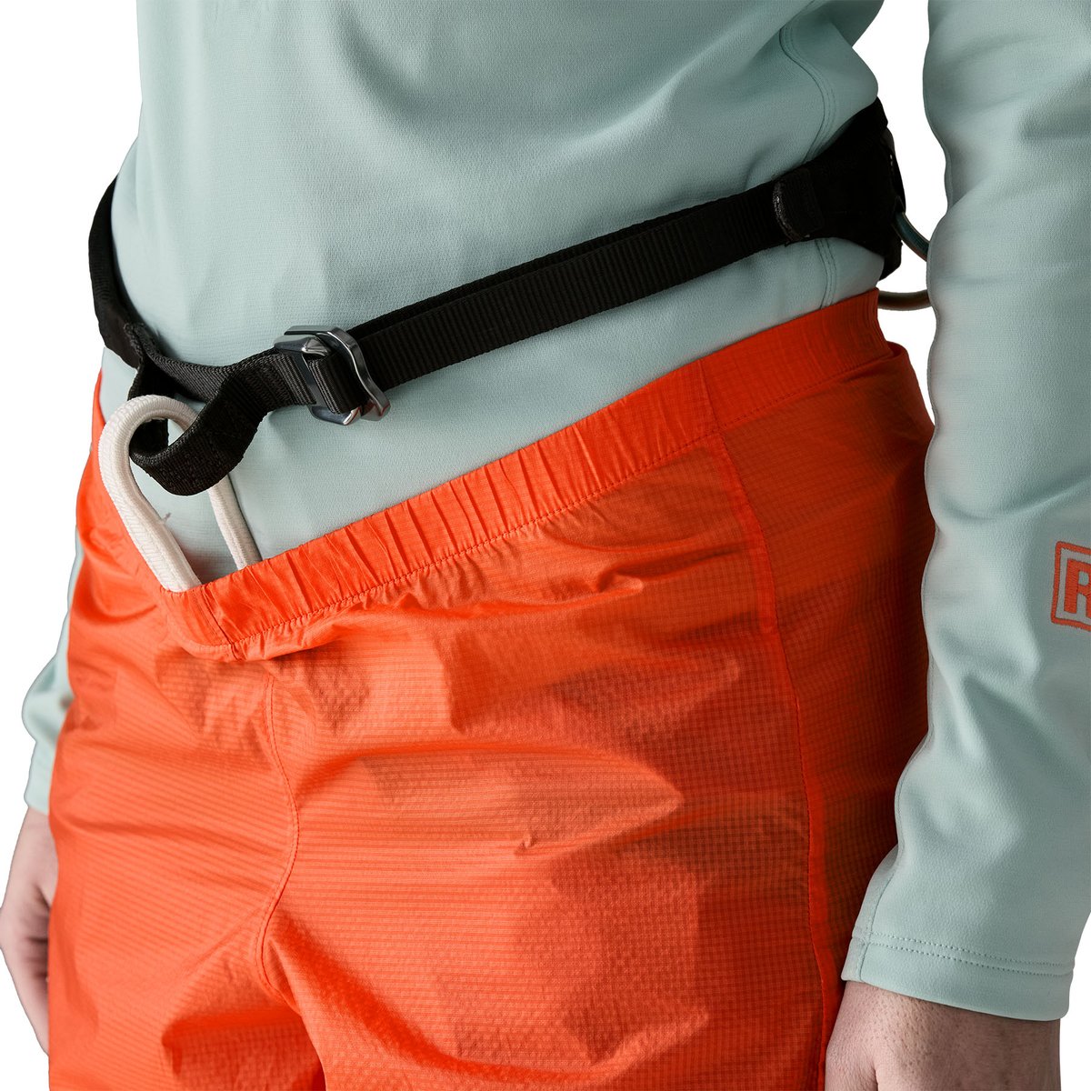 Climber wearing lightweight climbing pants with harness-compatible elastic waist.