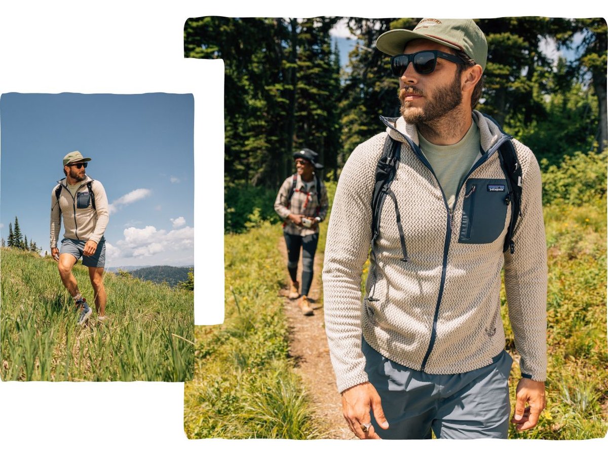 A person hikes through a grassy trail.