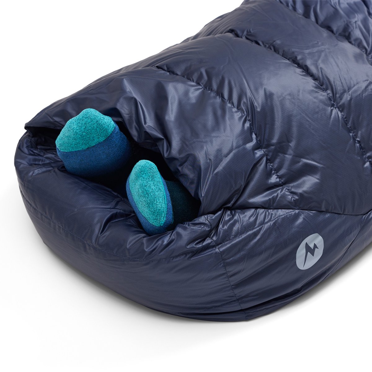 Two feet poke out of the Marmot Wraptor foot envelope, showcasing how heat can disperse without letting in too much cold. 