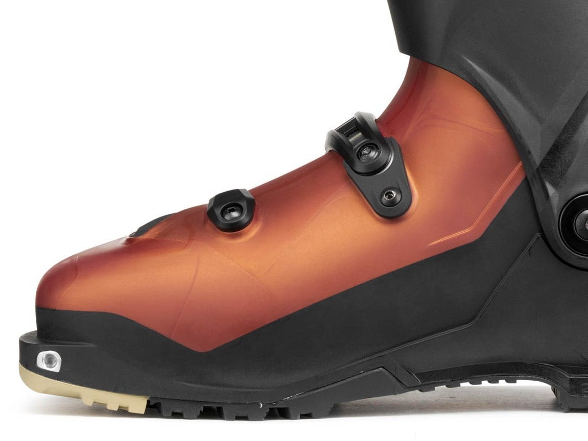 Lateral crop of SCARPA F1 RS lower shell in copper showing Grilamid construction, single buckle closure, and Vibram outsole edge